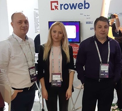3 people standing in front of Roweb Stand